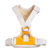 Yellow and white dog harness on a white background