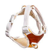 Dog harness with white straps and brown leather accents on a white background